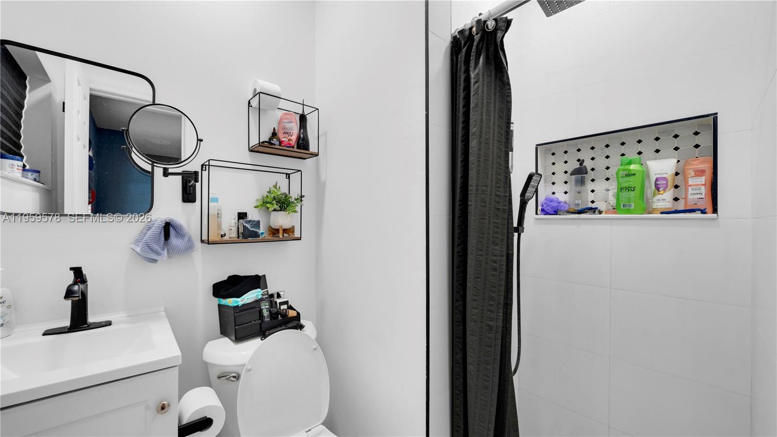 360 West 55th Street Hialeah, FL 33012 - Photo 16 of 20 a bathroom with a toilet and a mirror