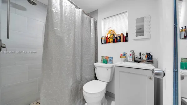a white toilet sitting next to a bathroom sink