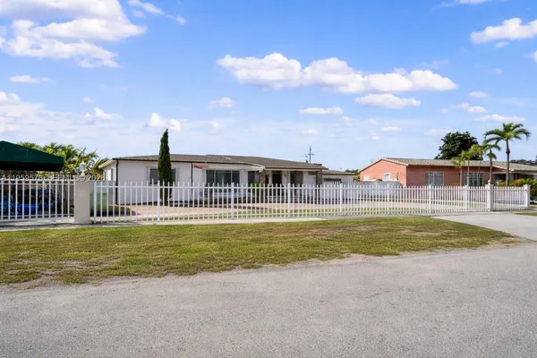 a view of a house with a swimming pool and a yard
