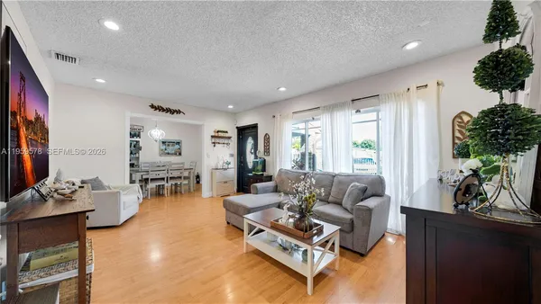 a living room with furniture fireplace and window