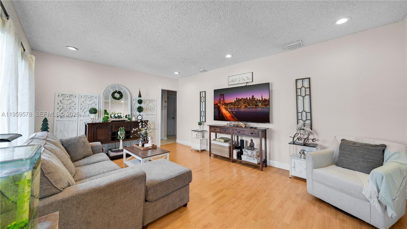 360 West 55th Street Hialeah, FL 33012 - Photo 4 of 20 a living room with furniture and a flat screen tv