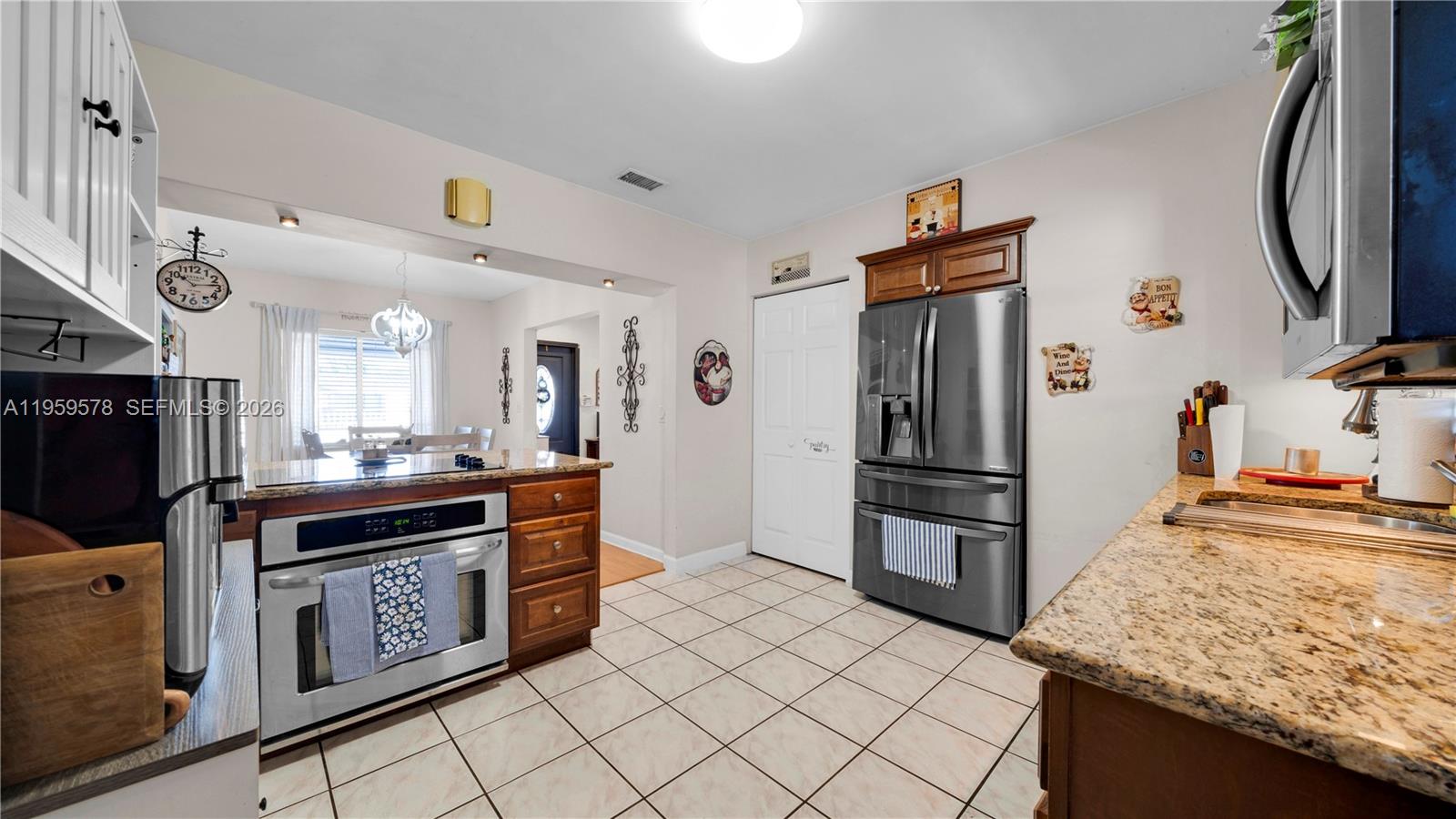 360 West 55th Street Hialeah, FL 33012 - Photo 7 of 20 a kitchen with stainless steel appliances granite countertop a refrigerator a stove and a sink