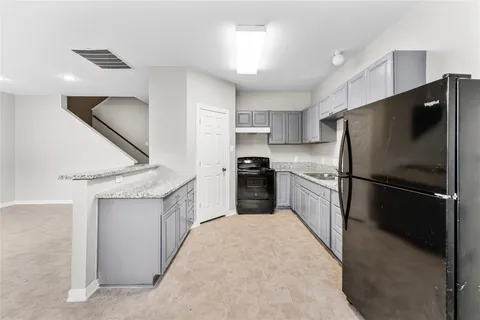 a kitchen with a refrigerator a sink and a stove