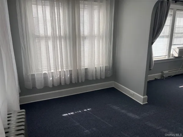 a view of room with window and hardwood floor