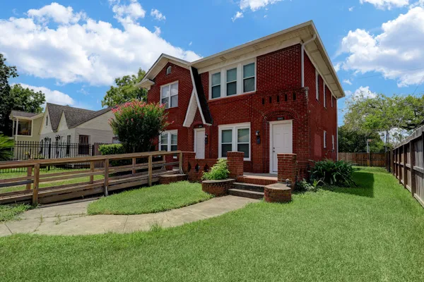a view of a house with a yard porch and sitting area