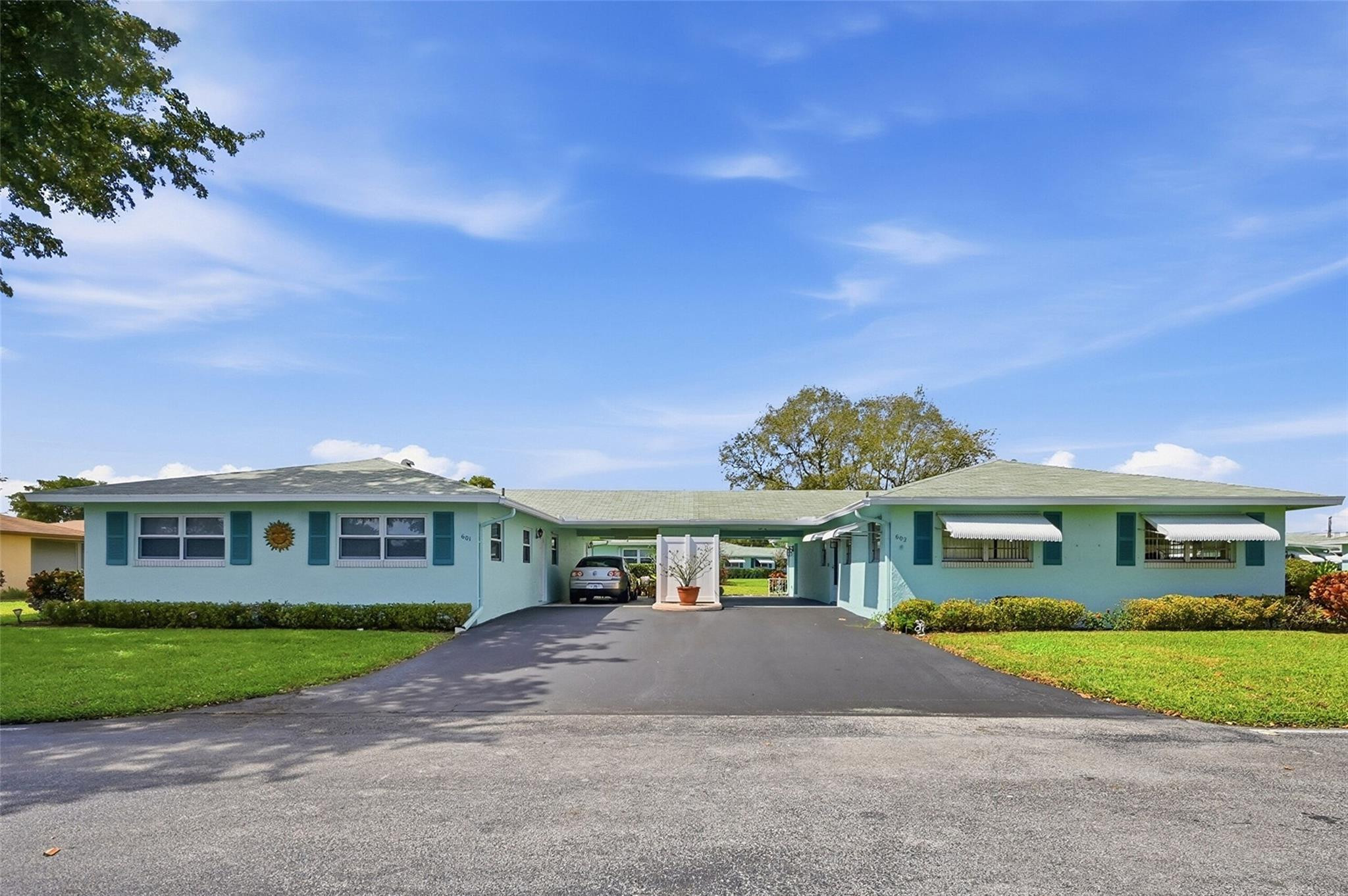 602 Hummingbird Lane, Unit 602 Delray Beach, FL 33445 - Photo 1 of 31 a front view of a residential houses with yard