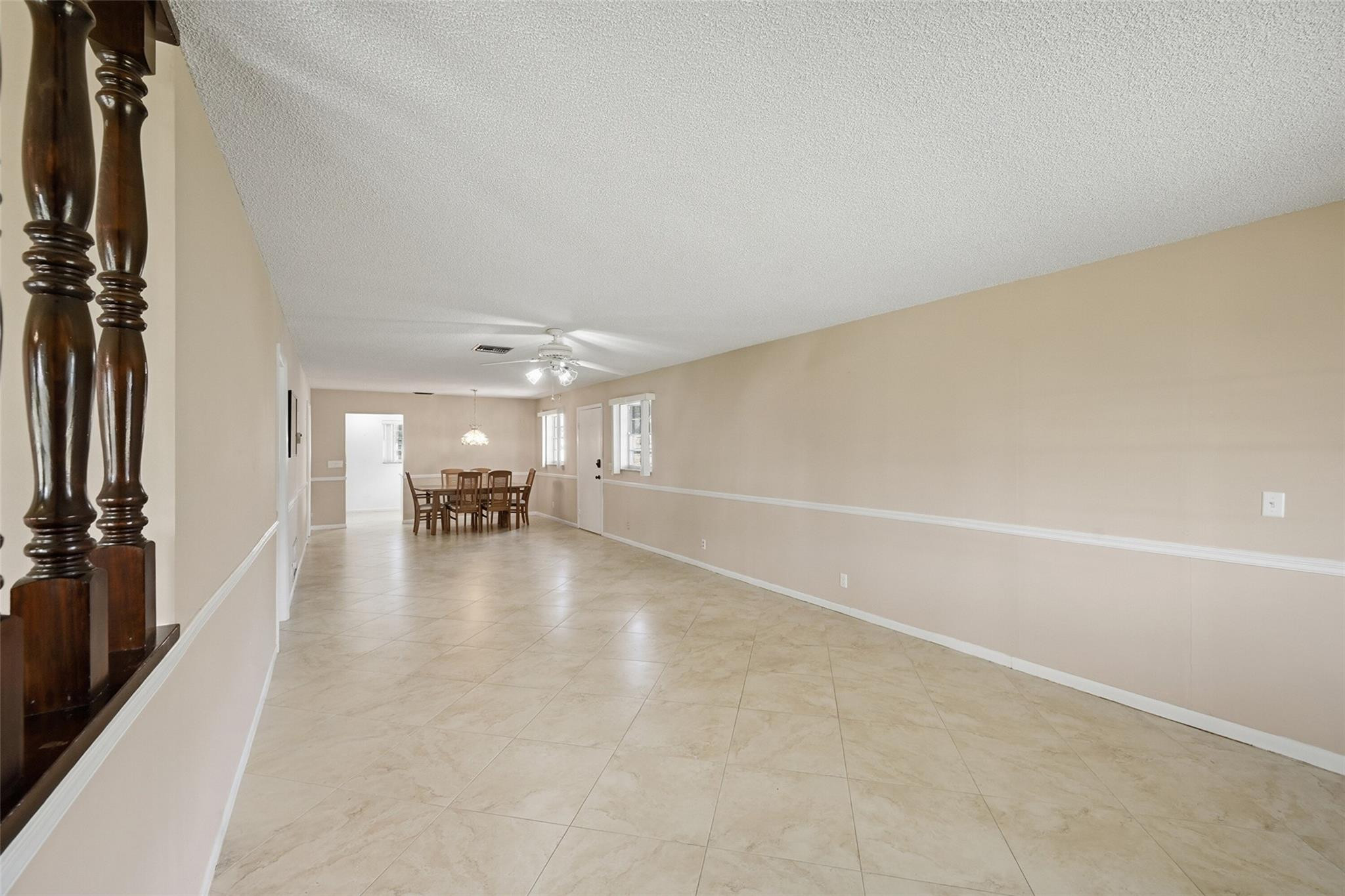 602 Hummingbird Lane, Unit 602 Delray Beach, FL 33445 - Photo 12 of 31 a view of a livingroom with furniture and floor to ceiling window