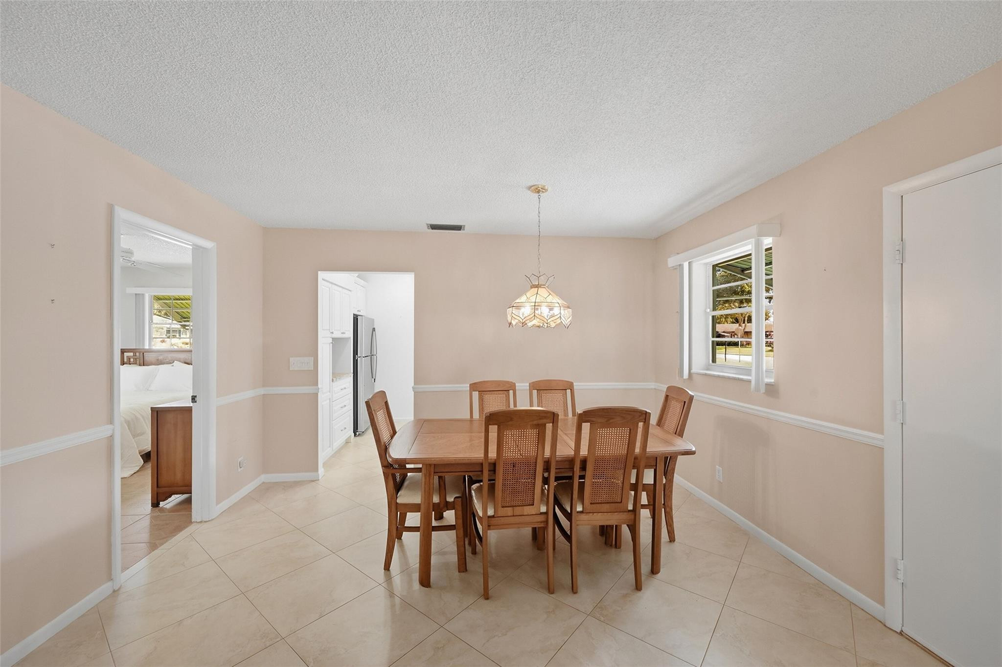 602 Hummingbird Lane, Unit 602 Delray Beach, FL 33445 - Photo 15 of 31 a view of a dining room with furniture and window