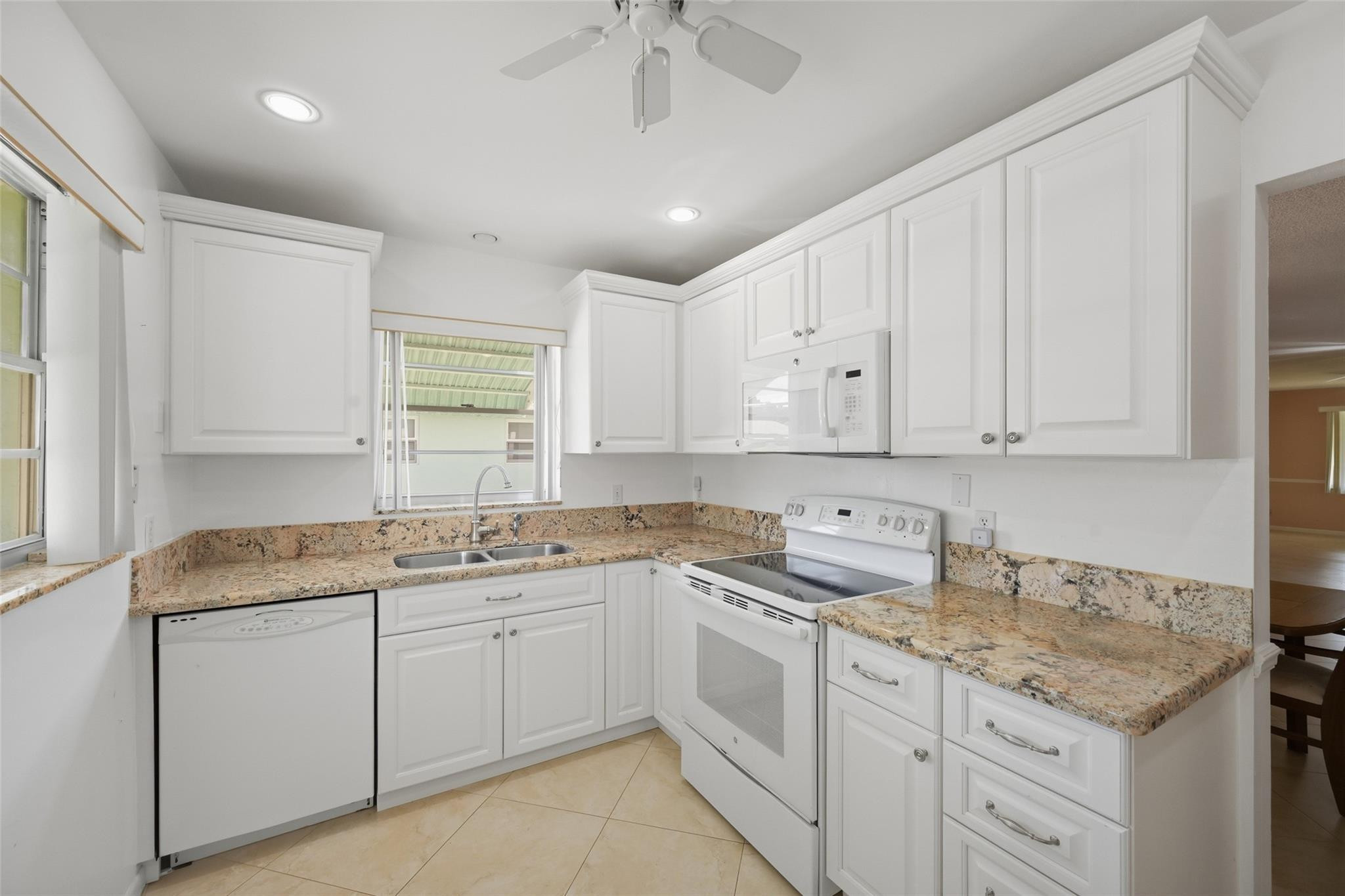 602 Hummingbird Lane, Unit 602 Delray Beach, FL 33445 - Photo 17 of 31 a kitchen with a sink stove and cabinets