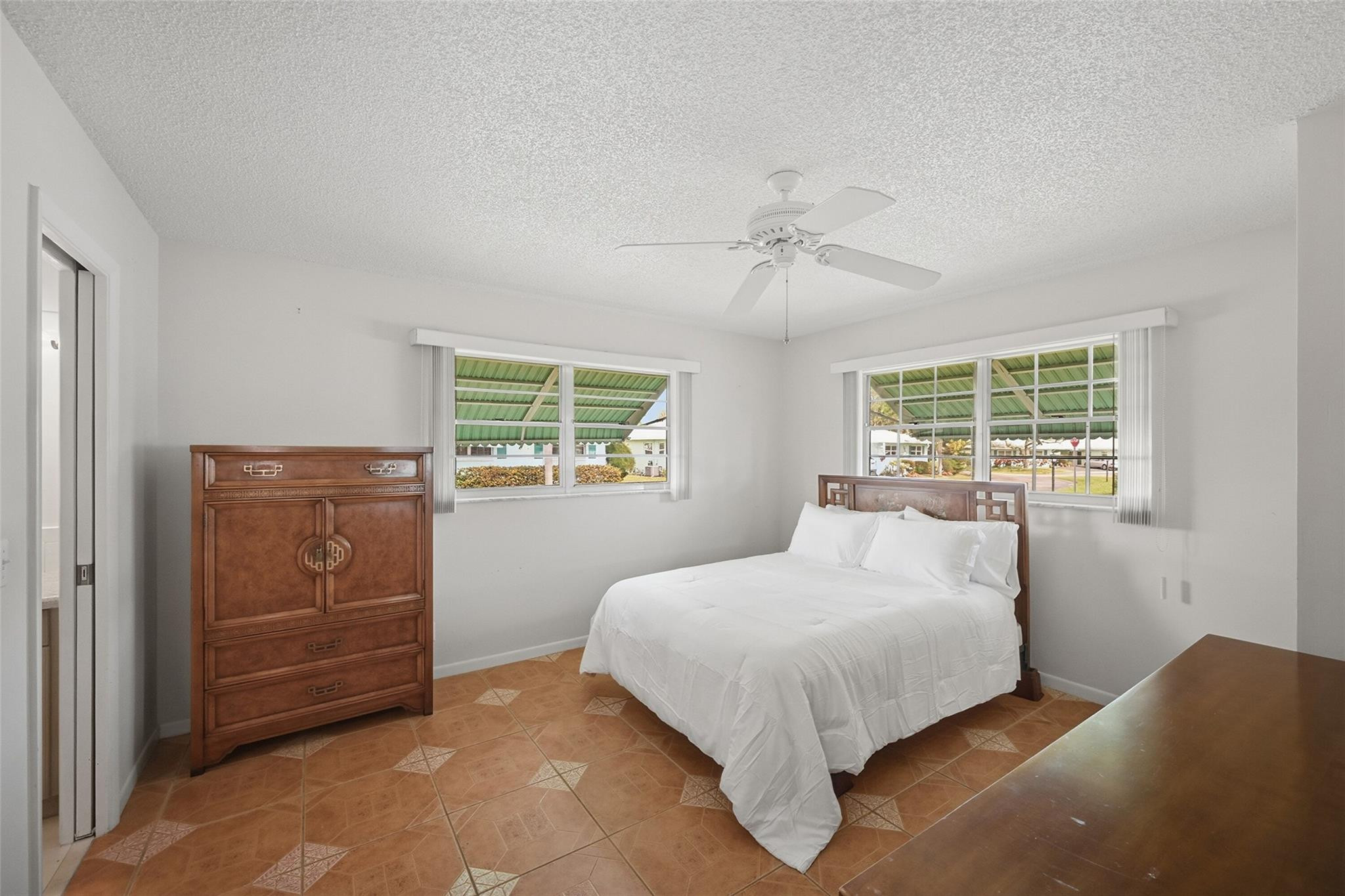 602 Hummingbird Lane, Unit 602 Delray Beach, FL 33445 - Photo 20 of 31 a bedroom with a large bed and a window