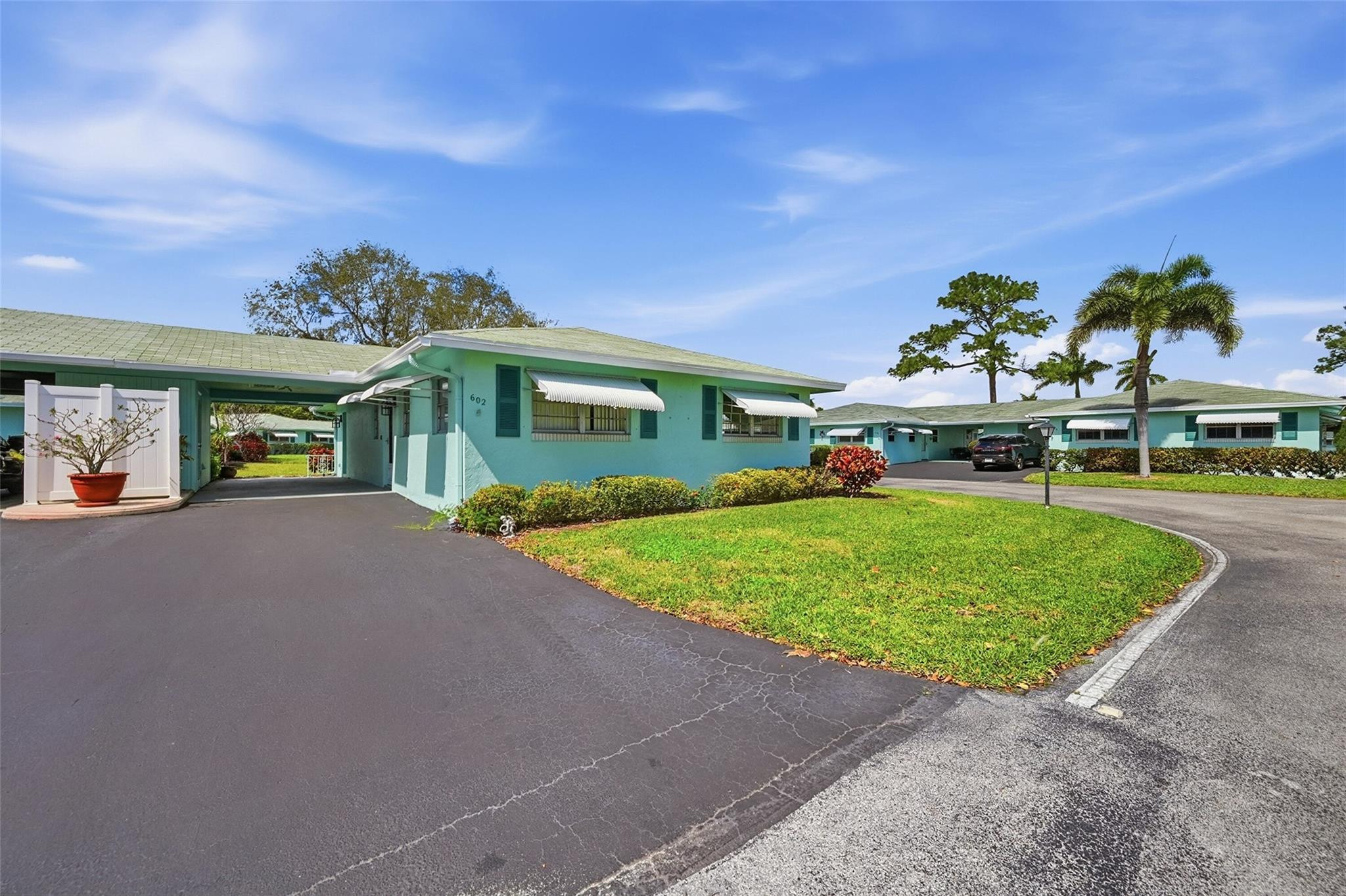 602 Hummingbird Lane, Unit 602 Delray Beach, FL 33445 - Photo 2 of 31 a view of a house with a yard