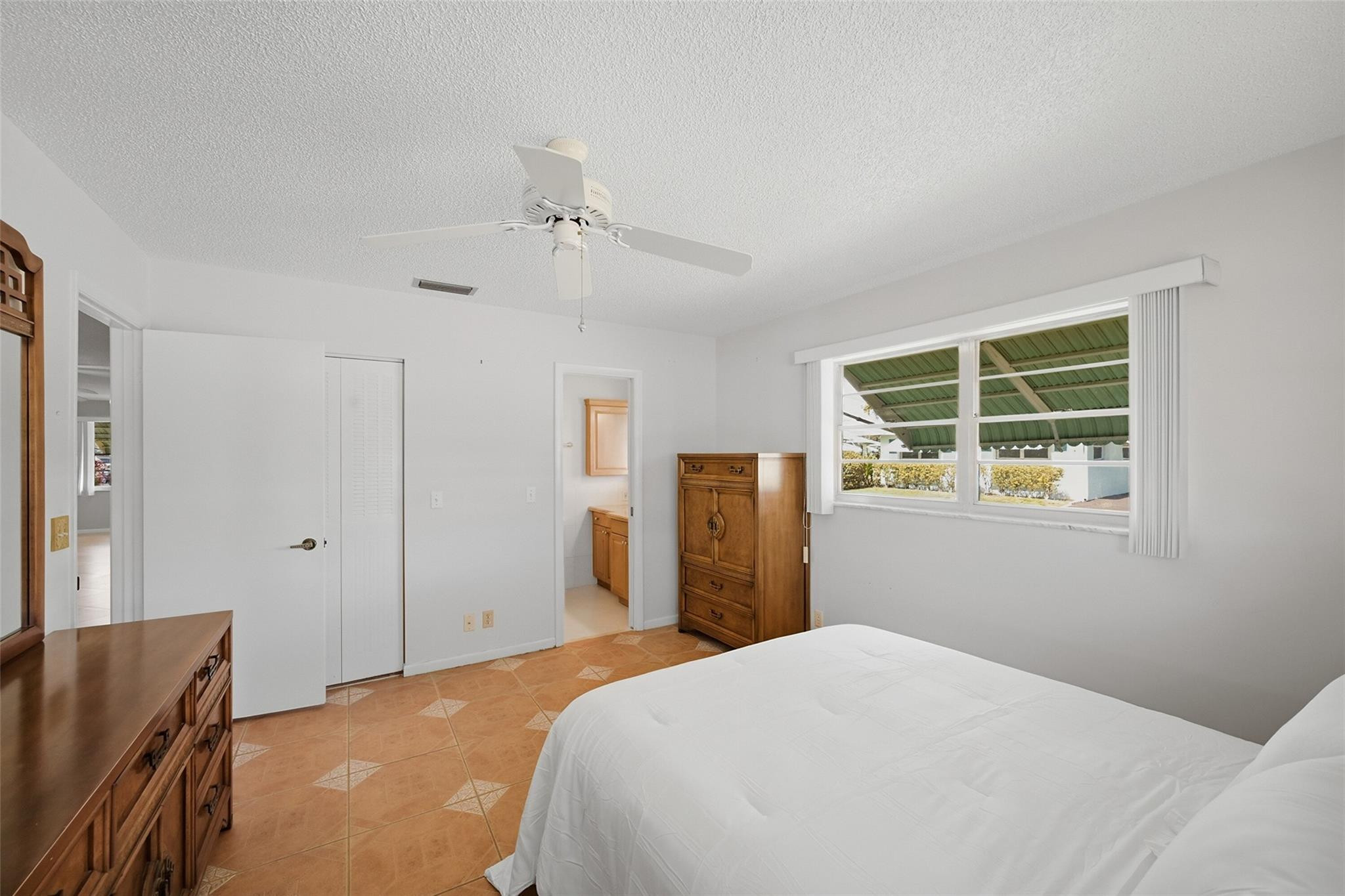 602 Hummingbird Lane, Unit 602 Delray Beach, FL 33445 - Photo 21 of 31 a bedroom with a bed and a window