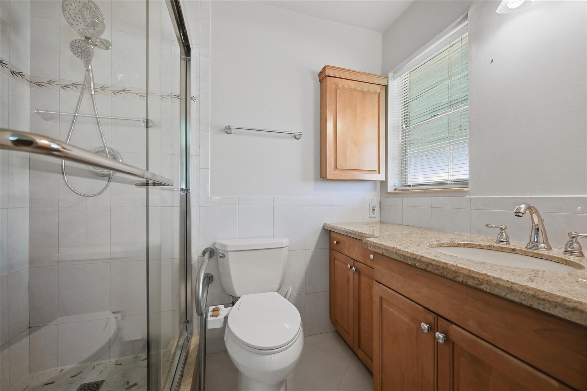 602 Hummingbird Lane, Unit 602 Delray Beach, FL 33445 - Photo 23 of 31 a bathroom with a granite countertop toilet sink and mirror