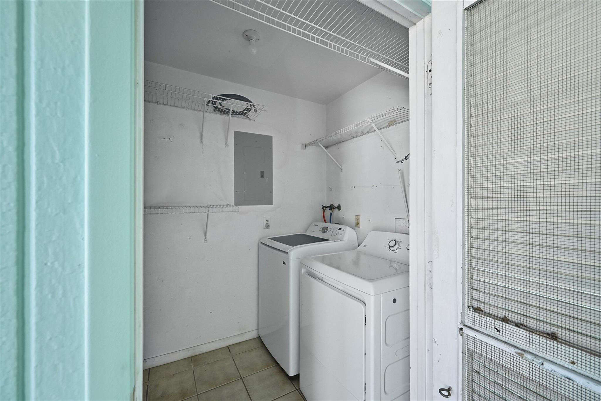 602 Hummingbird Lane, Unit 602 Delray Beach, FL 33445 - Photo 28 of 31 a utility room with cabinets washer and dryer