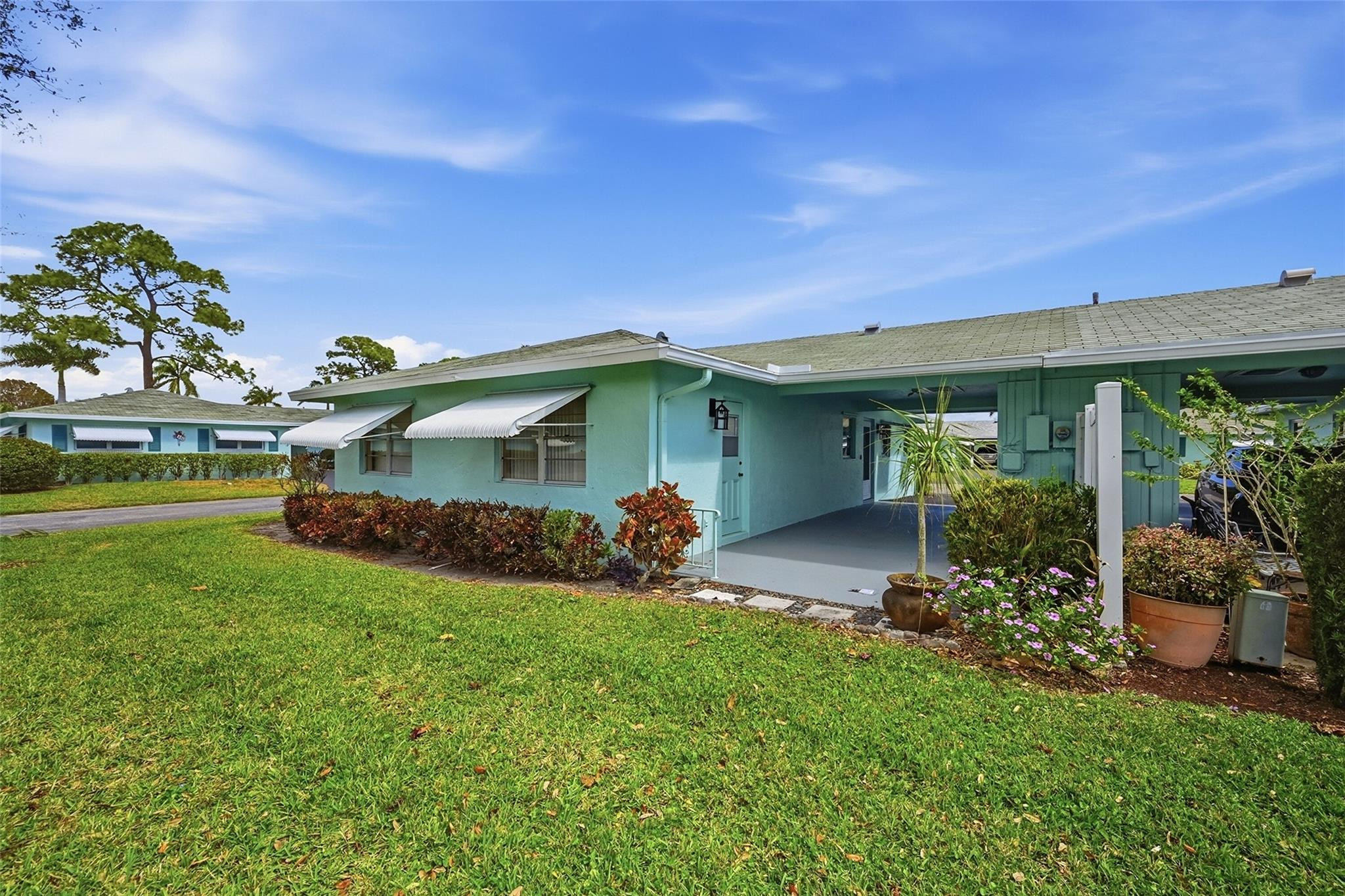 602 Hummingbird Lane, Unit 602 Delray Beach, FL 33445 - Photo 6 of 31 a view of a house with backyard and porch