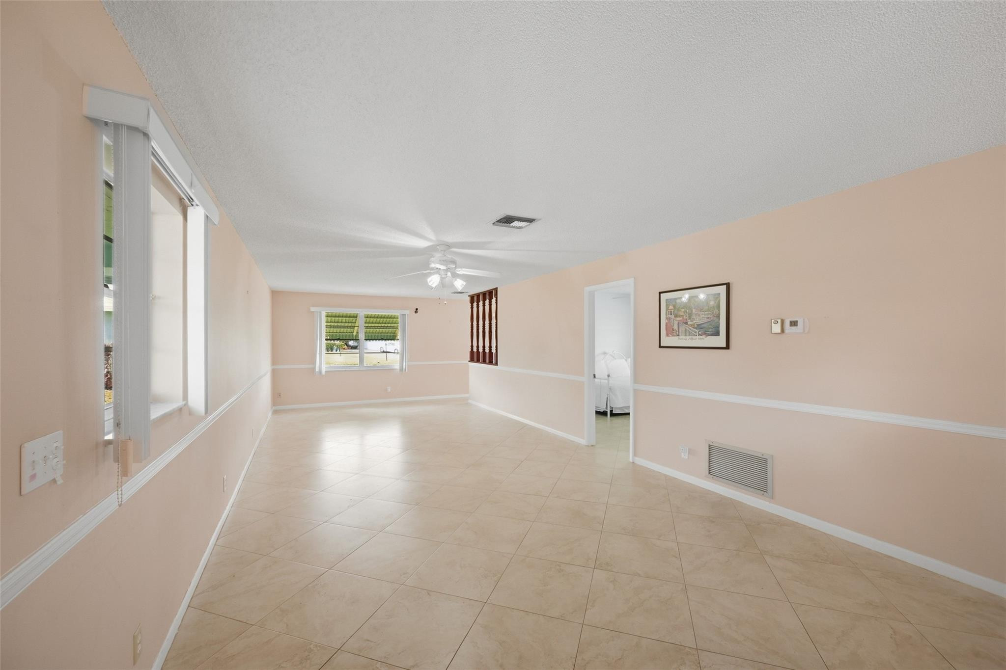 602 Hummingbird Lane, Unit 602 Delray Beach, FL 33445 - Photo 9 of 31 a view of empty room with wooden floor and windows