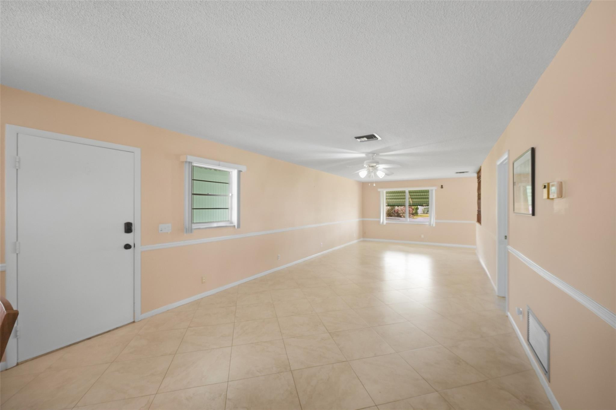 602 Hummingbird Lane, Unit 602 Delray Beach, FL 33445 - Photo 10 of 31 a view of a livingroom with wooden floor and a window