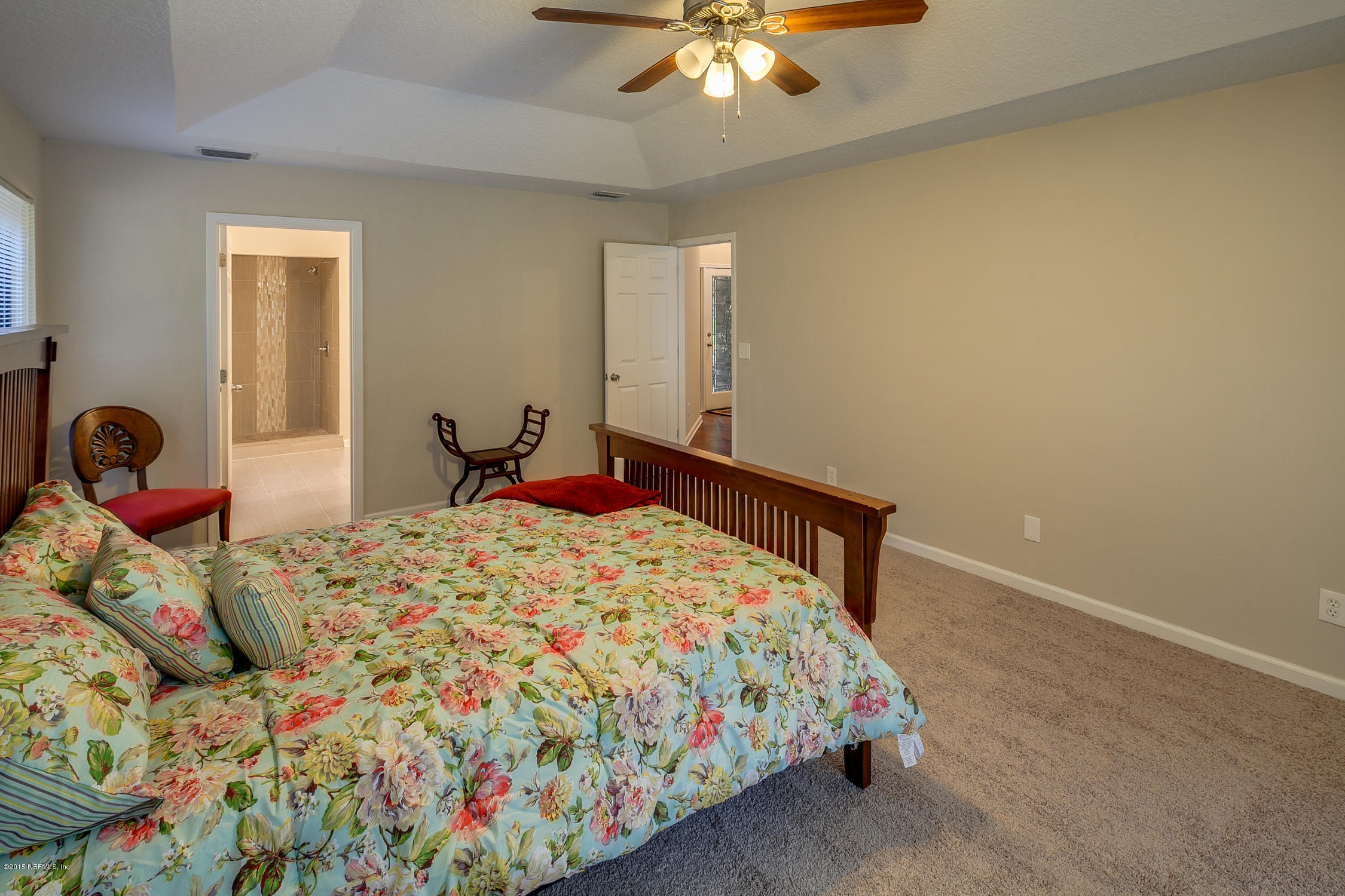 4265 Wicks Branch Road St. Augustine, FL 32086 - Photo 17 of 35 a bedroom with a bed and a chandelier
