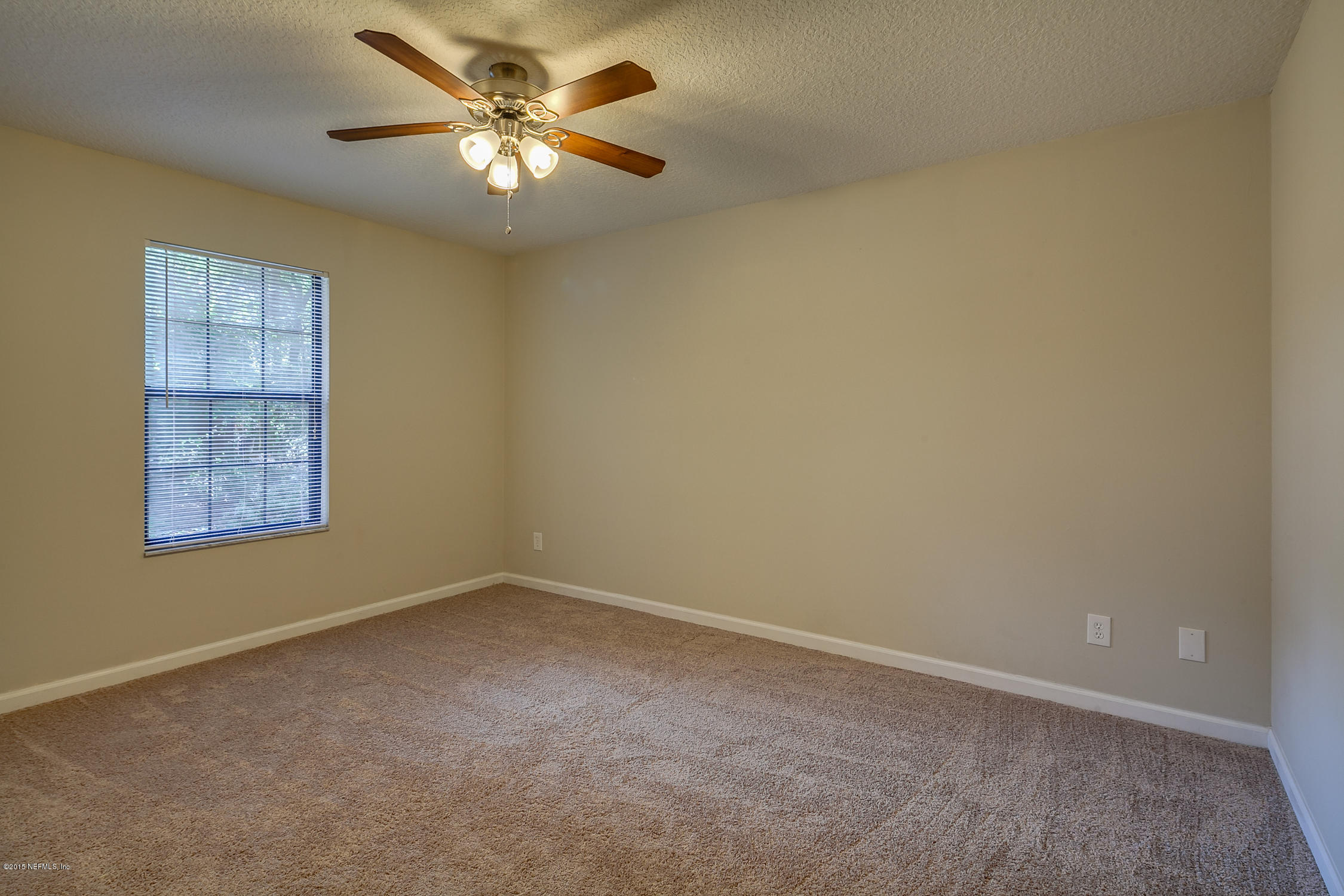 4265 Wicks Branch Road St. Augustine, FL 32086 - Photo 24 of 35 an empty room with windows and fan