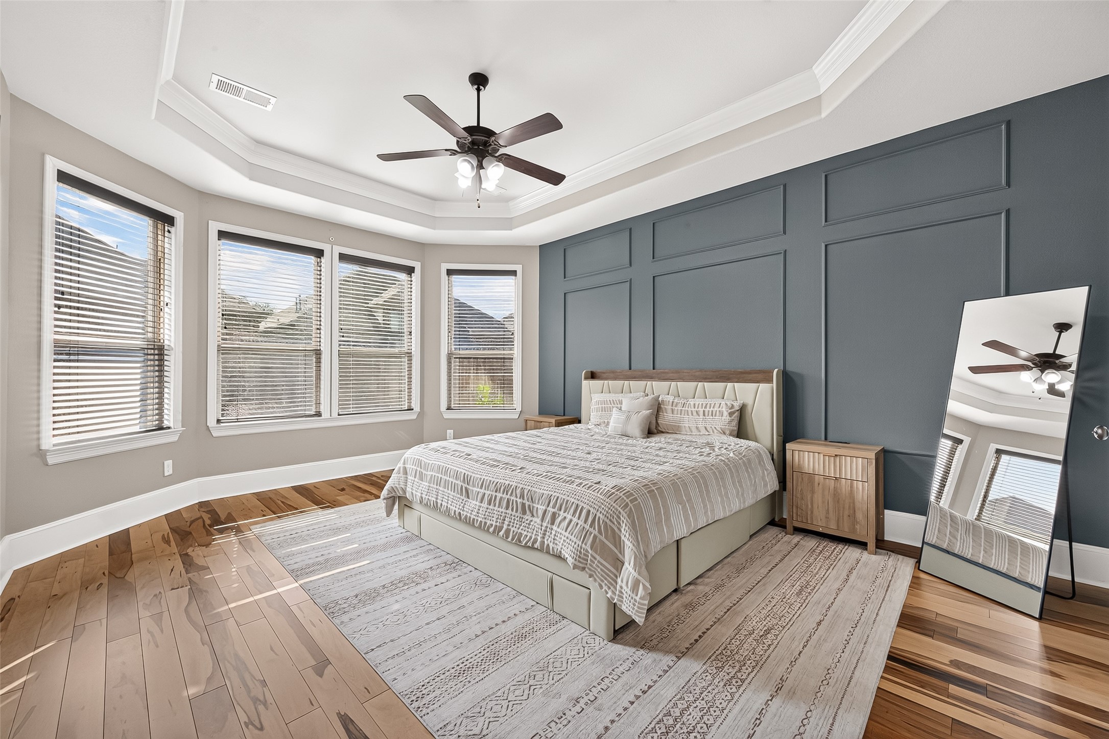4207 Reagan Ridge Court Richmond, TX 77406 - Photo 29 of 50 First-floor primary suite with natural light and a stylish accent wall.