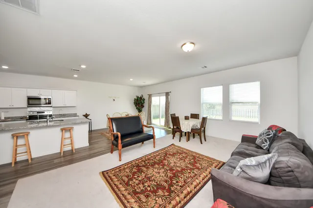 a living room with furniture and a rug
