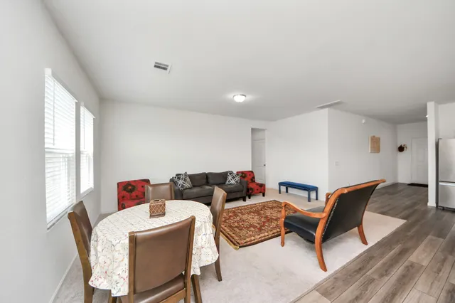 a dining room with a table chairs and entryway