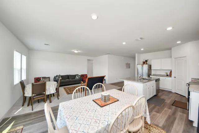 a kitchen with stainless steel appliances granite countertop a sink and refrigerator