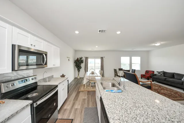 a kitchen with furniture a counter space and appliances