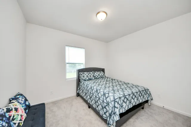 a bedroom with a bed and a dresser