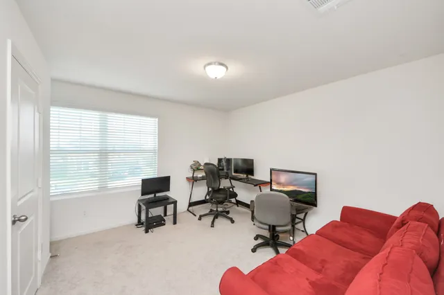 a bedroom with two beds and a desk