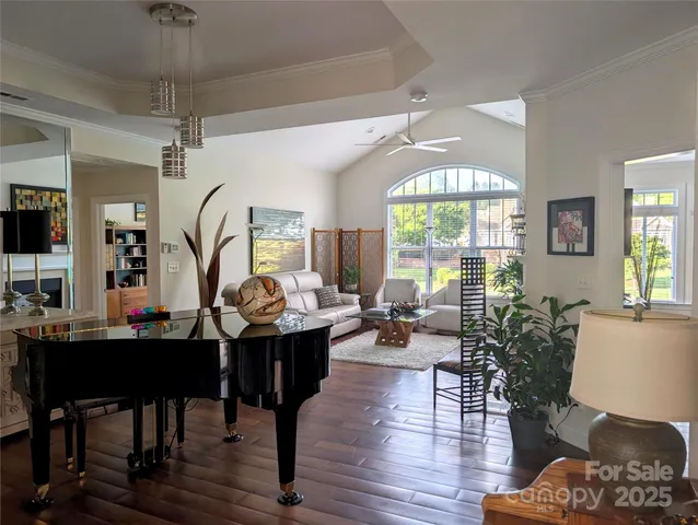 a living room with furniture a window and a chandelier