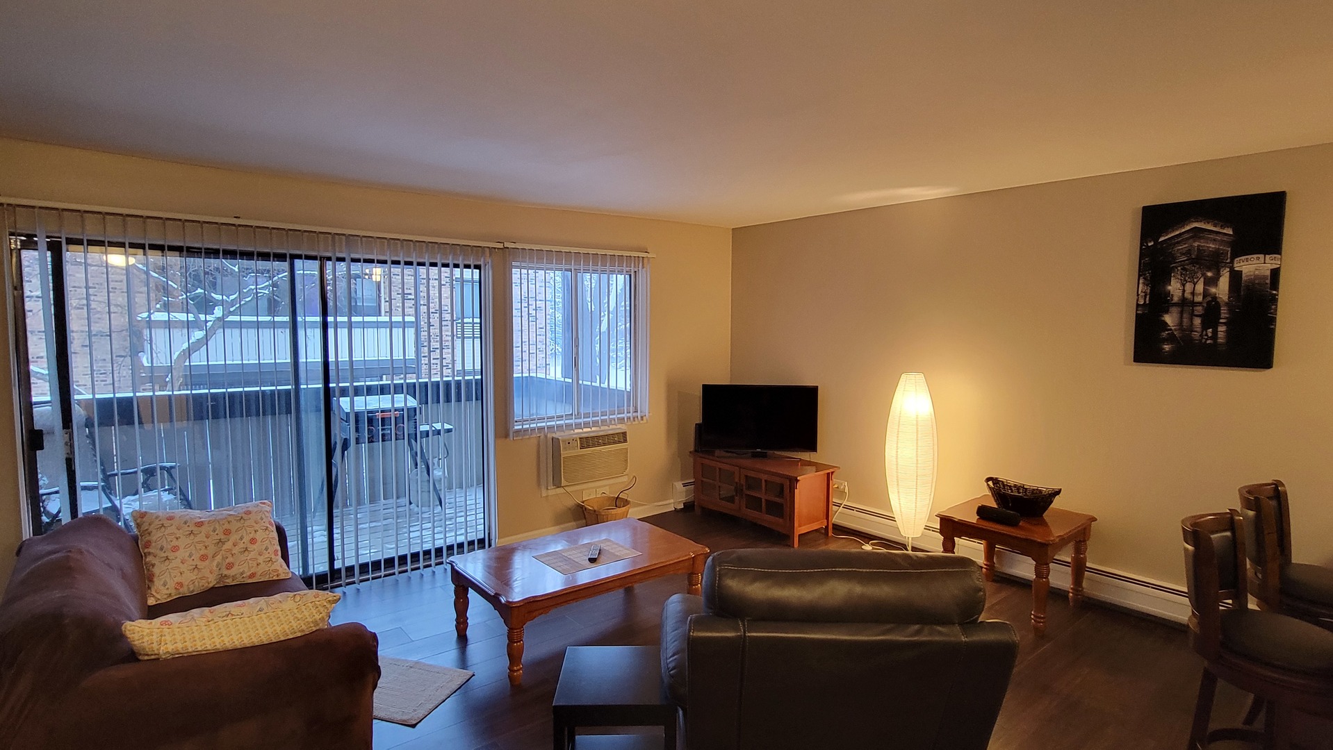 1810 Hemlock Place, Unit 209 Schaumburg, IL 60173 - Photo 5 of 13 a living room with furniture a flat screen tv and a window