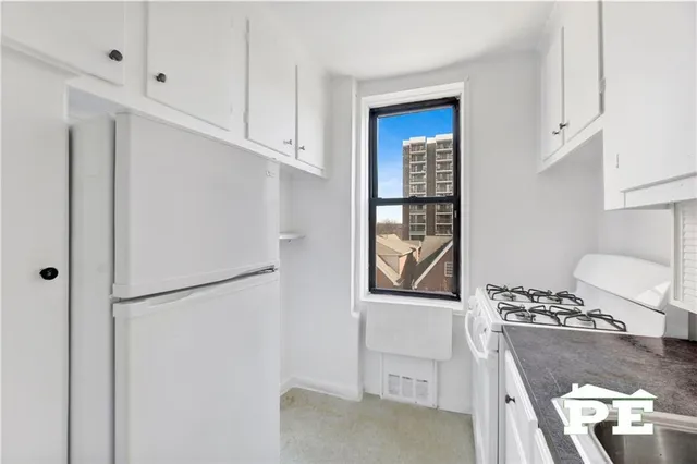 a kitchen with a refrigerator and a stove