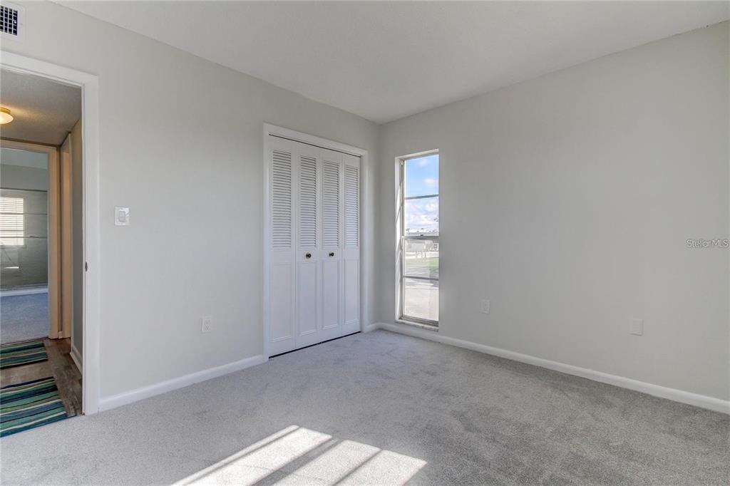 4901 Onyx Lane, Unit 204 New Port Richey, FL 34652 - Photo 13 of 46 an empty room with windows