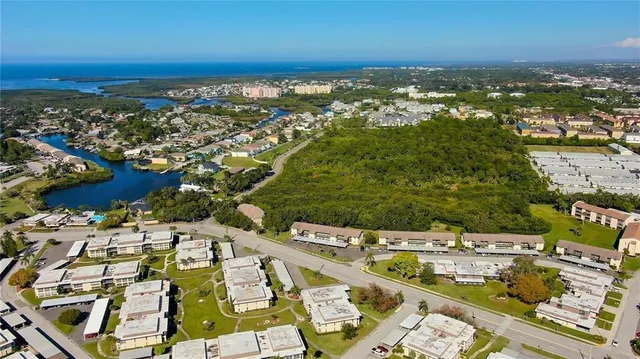 an aerial view of a house with garden space and street view