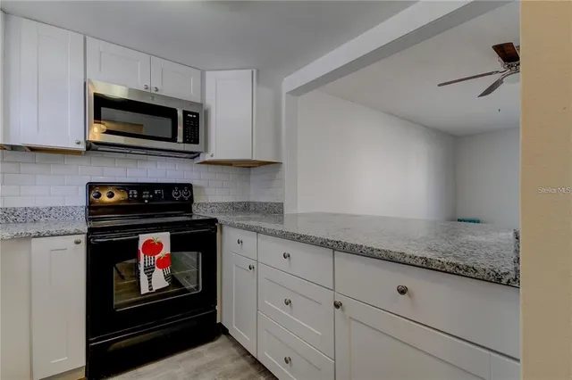 a view of a sink and a refrigerator in a kitchen