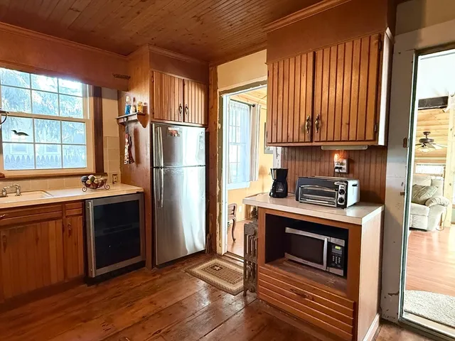 a kitchen with stainless steel appliances kitchen island granite countertop a stove and a refrigerator