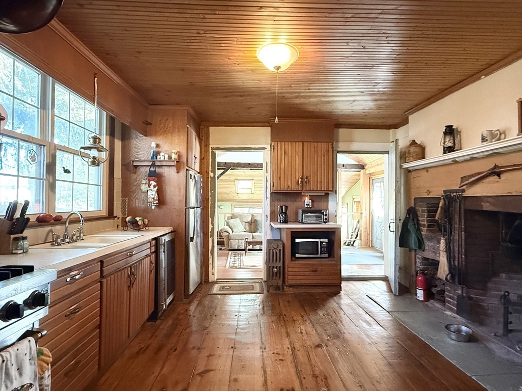 334 Elm Street West Springfield, MA 01089 - Photo 14 of 42 a kitchen with stainless steel appliances kitchen island granite countertop a stove and a refrigerator