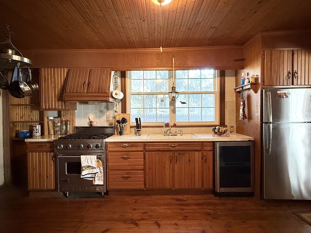 334 Elm Street West Springfield, MA 01089 - Photo 15 of 42 a kitchen with stainless steel appliances granite countertop a stove a refrigerator and a sink with wooden cabinets