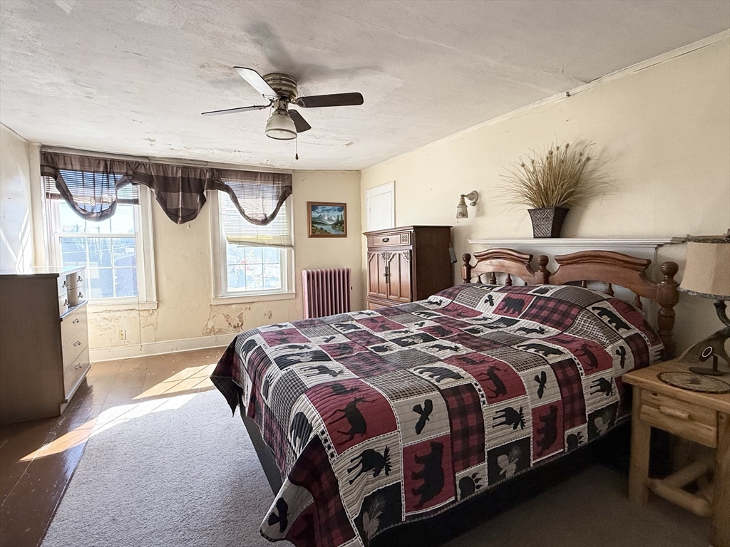 334 Elm Street West Springfield, MA 01089 - Photo 31 of 42 a bedroom with a bed a dresser next to a window with the outer view