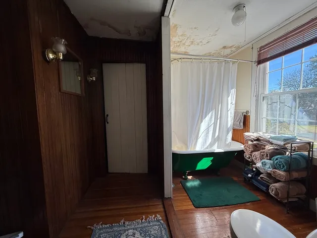 a living room with hardwood floor and a ceiling fan