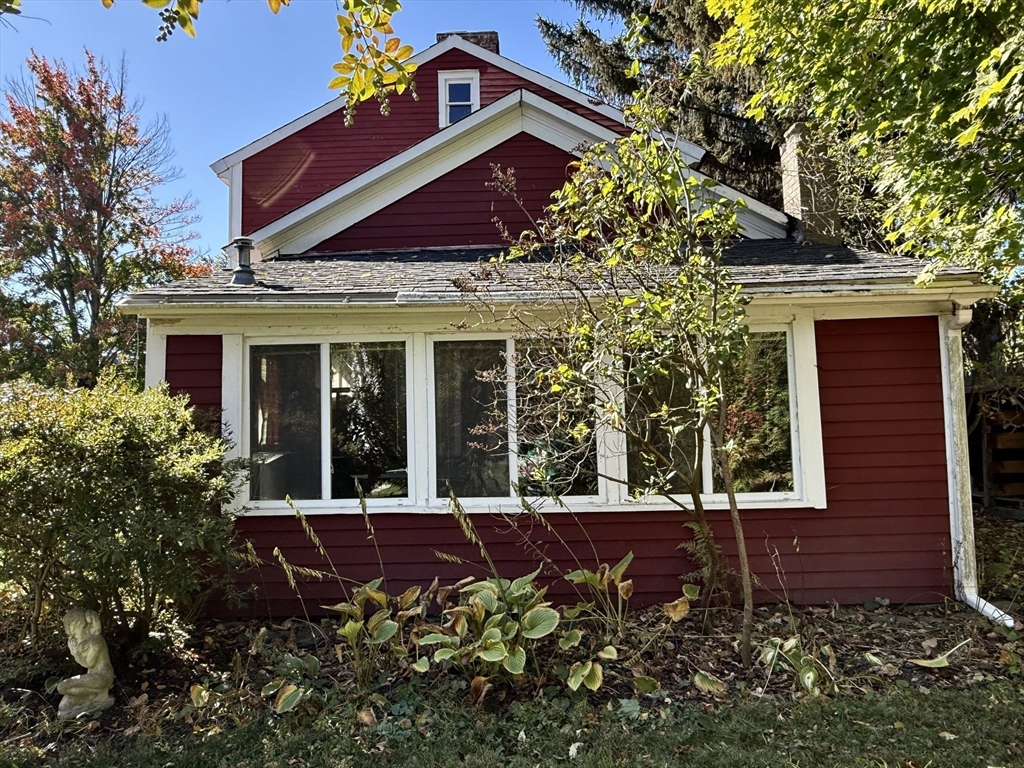 334 Elm Street West Springfield, MA 01089 - Photo 41 of 42 a view of a house with brick walls and a flower garden