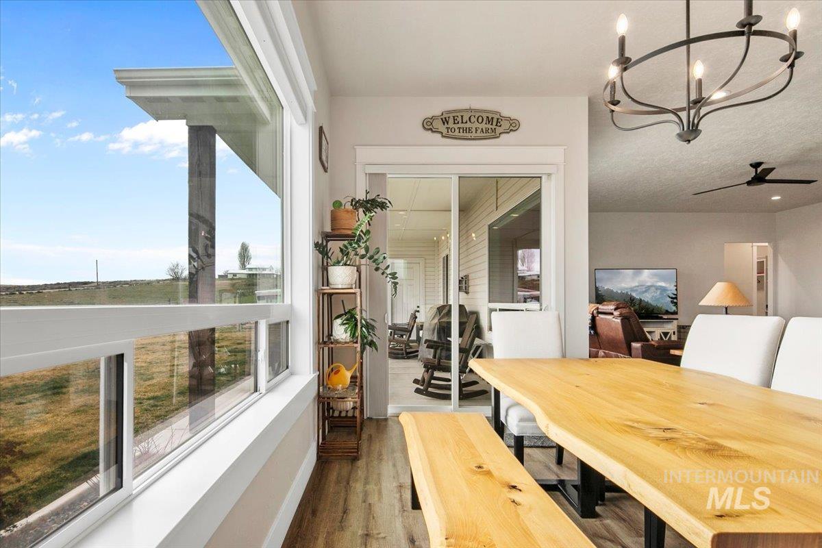 6721 El Paso Road Caldwell, ID 83607 - Photo 15 of 50 Dining area with a chandelier, wood finished floors, and a ceiling fan