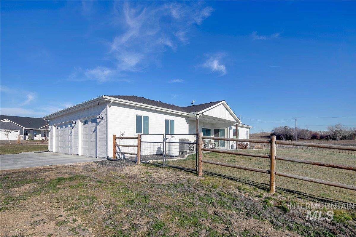 6721 El Paso Road Caldwell, ID 83607 - Photo 34 of 50 View of home's exterior with a gate, driveway, and an attached garage