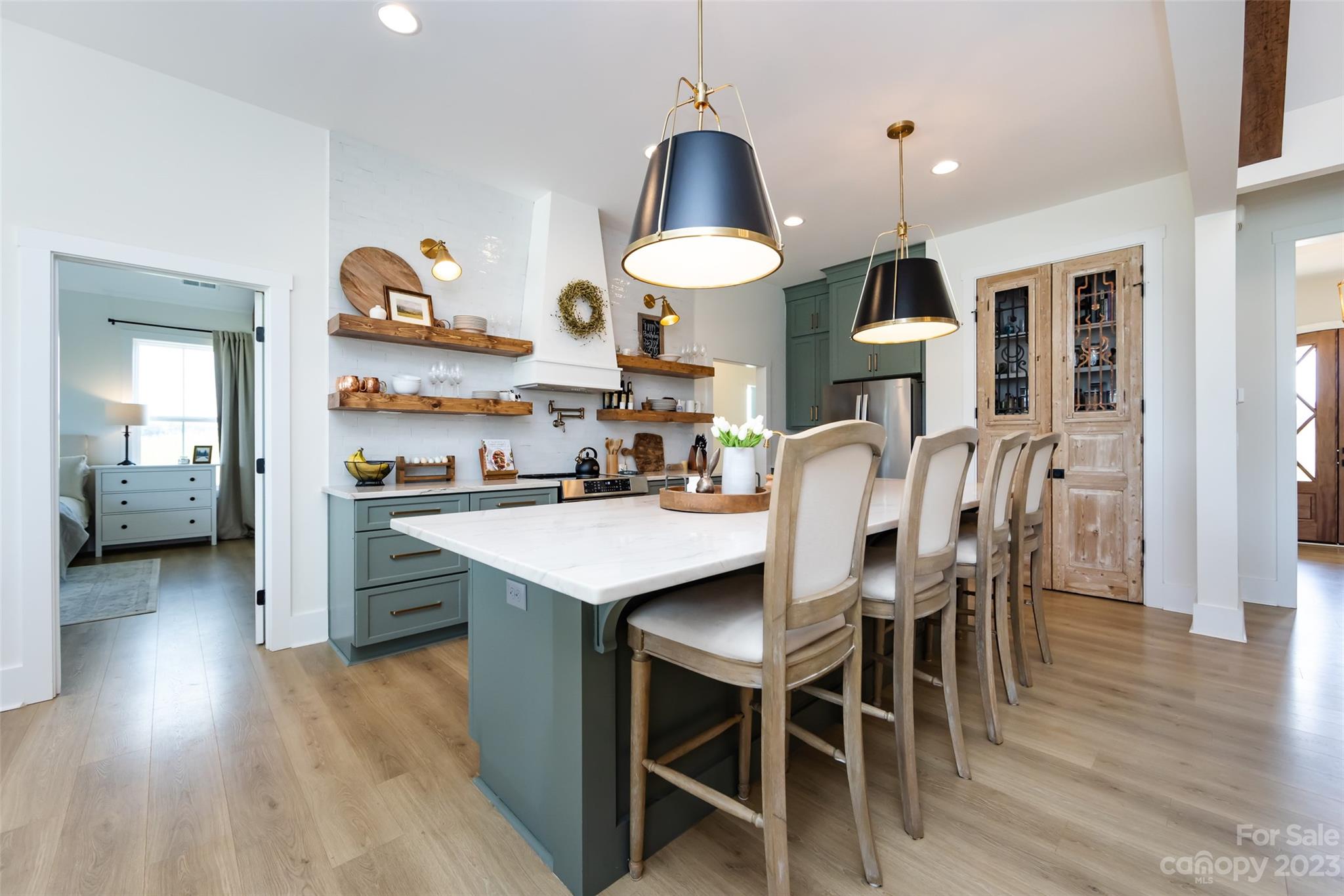 4316 Nesbit Road Monroe, NC 28112 - Photo 8 of 47 a kitchen with stainless steel appliances kitchen island granite countertop a table chairs in it and wooden floors