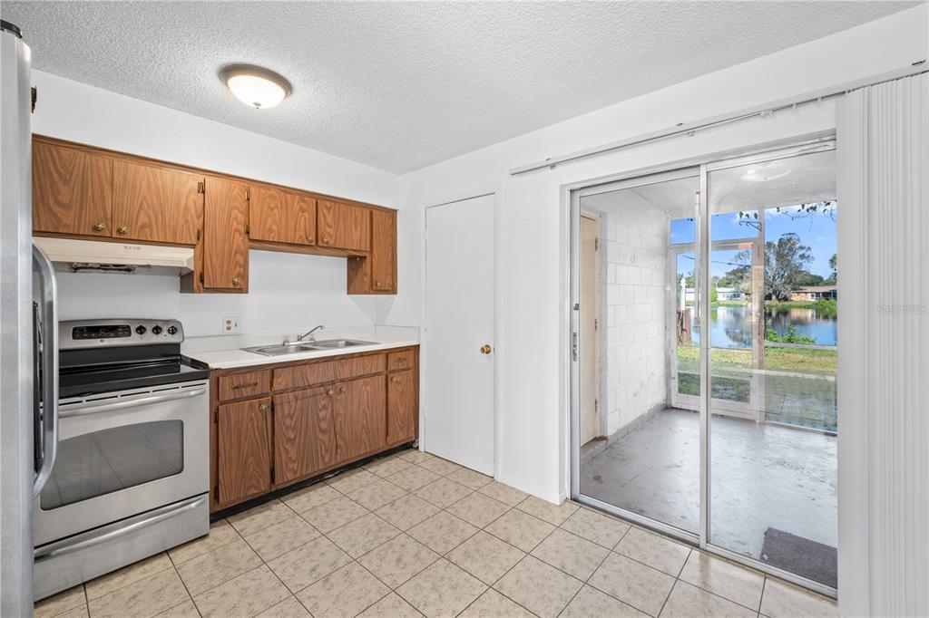 764 Lunar Lake Circle Cocoa, FL 32926 - Photo 9 of 17 a kitchen with granite countertop a refrigerator and white cabinets