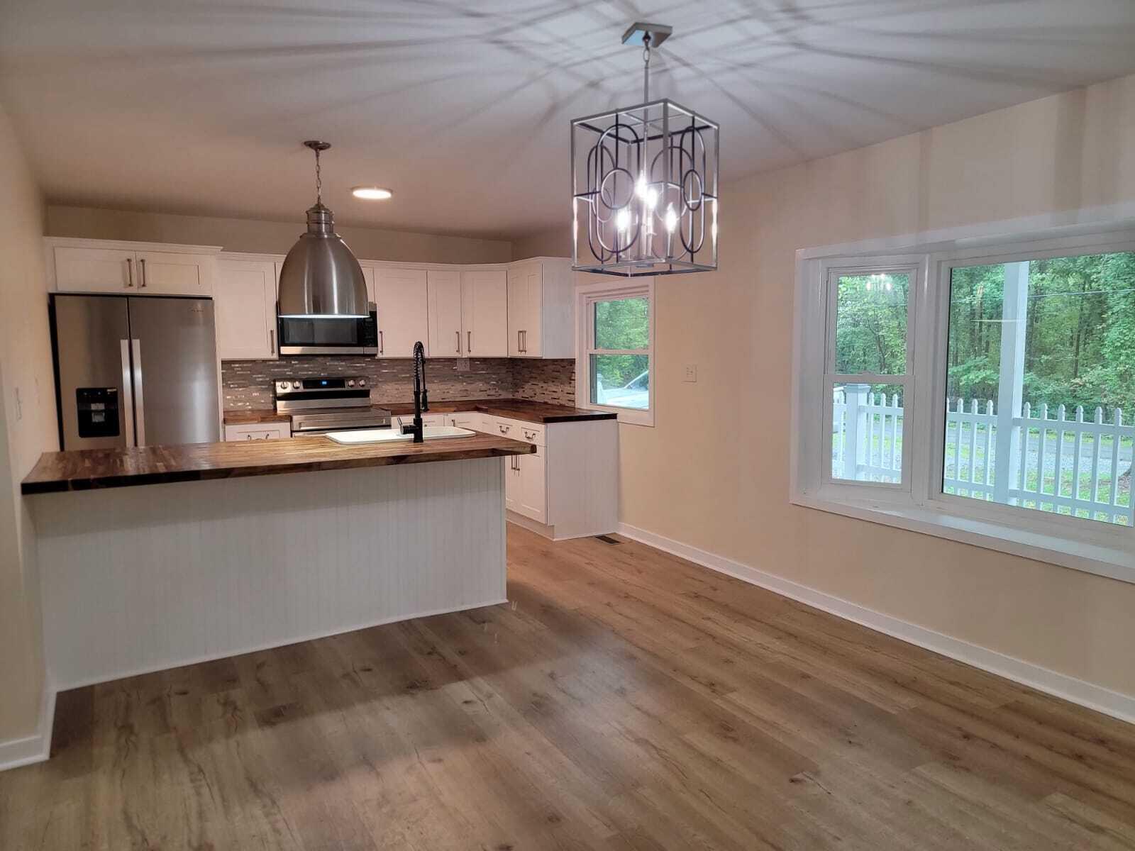 640 Cooks Knob Road Ferrum, VA 24088 - Photo 11 of 50 a large kitchen with kitchen island stainless steel appliances a large counter space a sink and appliances