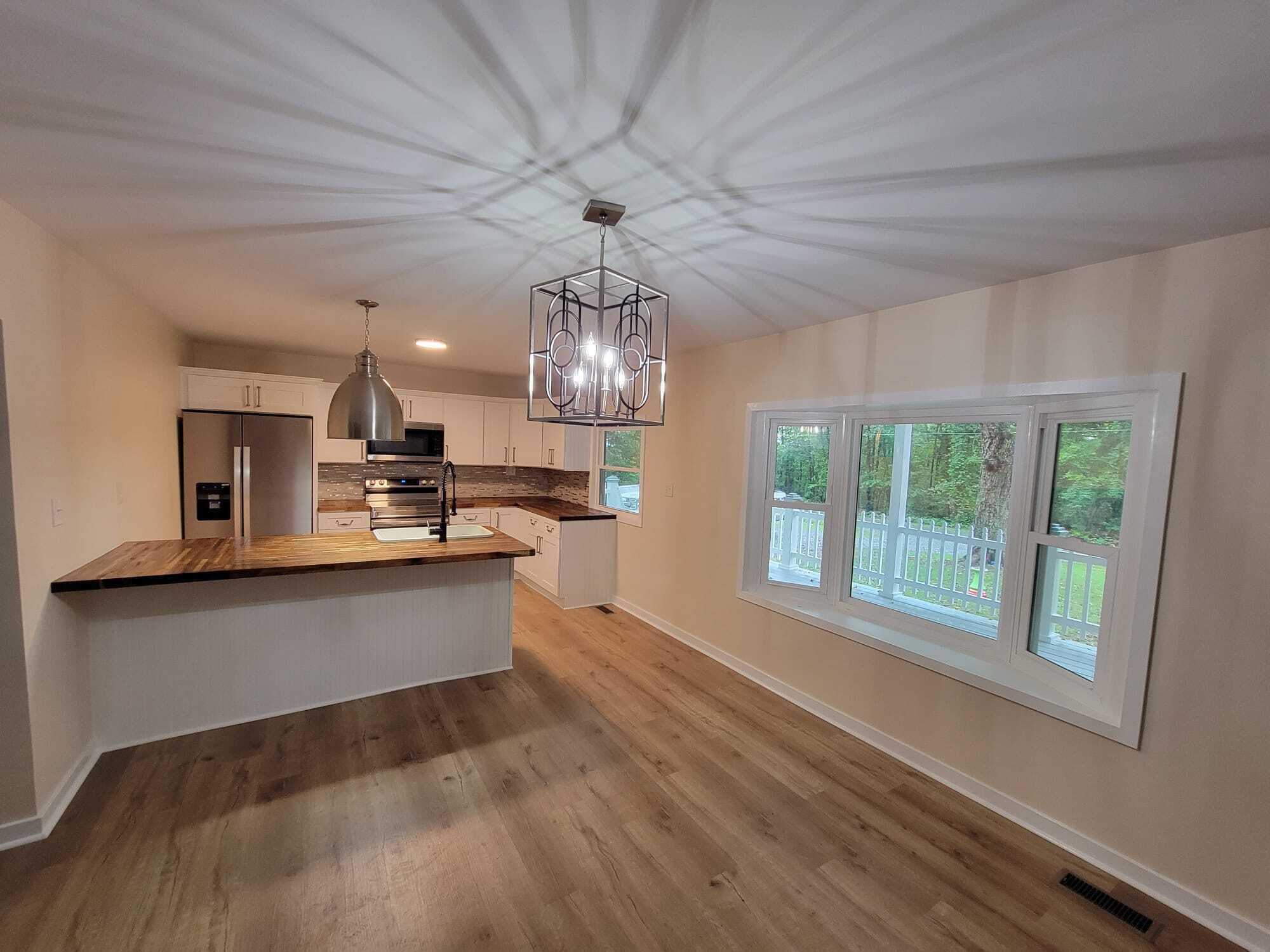 640 Cooks Knob Road Ferrum, VA 24088 - Photo 12 of 50 a large kitchen with kitchen island granite countertop a large window cabinets and stainless steel appliances