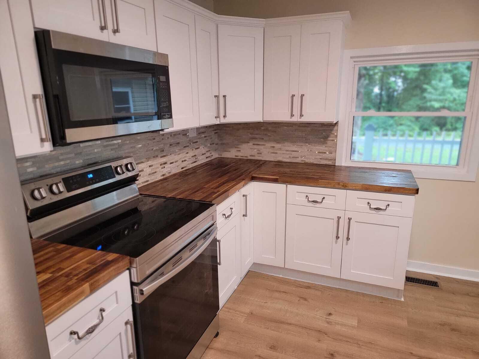 640 Cooks Knob Road Ferrum, VA 24088 - Photo 9 of 50 a kitchen with granite countertop white cabinets and black appliances