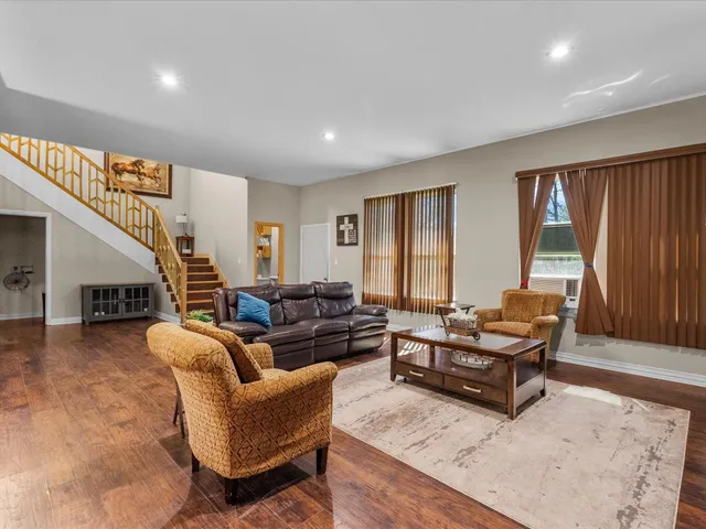 a living room with furniture and a large window